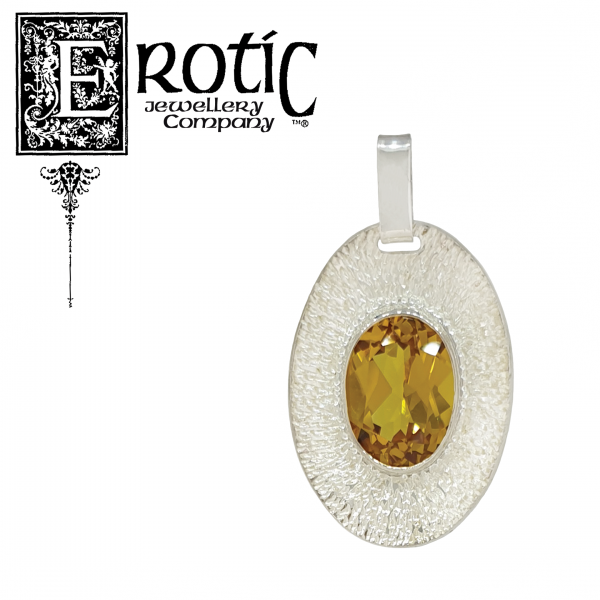 Sterling silver pendant with golden synthetic corundum with stone surrounded by textured background. Handmade by Paul Amey.